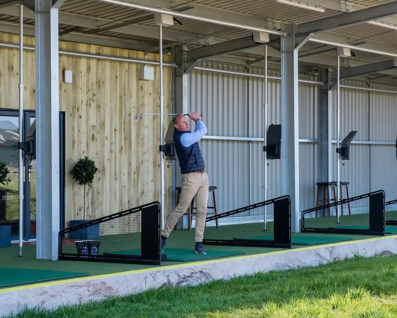 Robert Ashbrook mid-swing at the Ashbrook Golf Zone bay